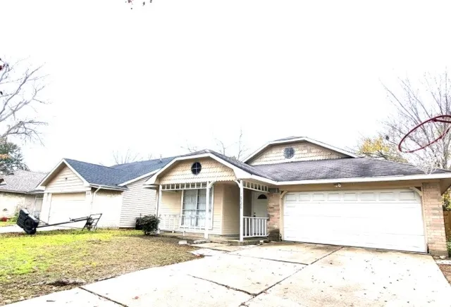 an empty room with windows and fireplace