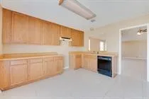 a view of a kitchen with a sink stove and cabinets