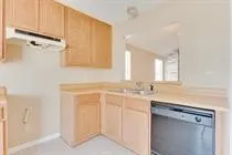 a view of a kitchen with refrigerator stove and cabinets