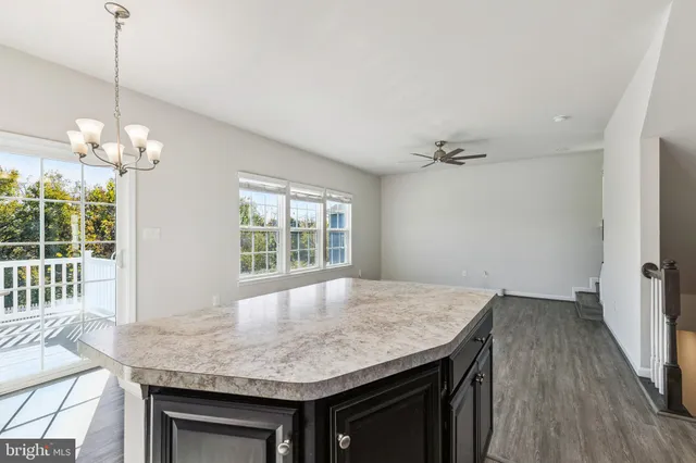 a kitchen with a table and chairs