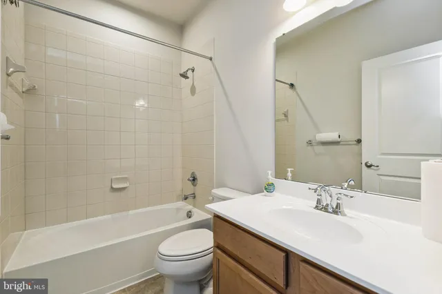 a bathroom with a sink a toilet and a bathtub