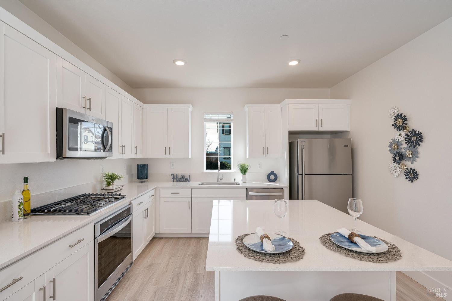 6054 Oxford Place Rohnert Park, CA 94928 - Photo 14 of 44 a kitchen with stainless steel appliances a white table and chairs