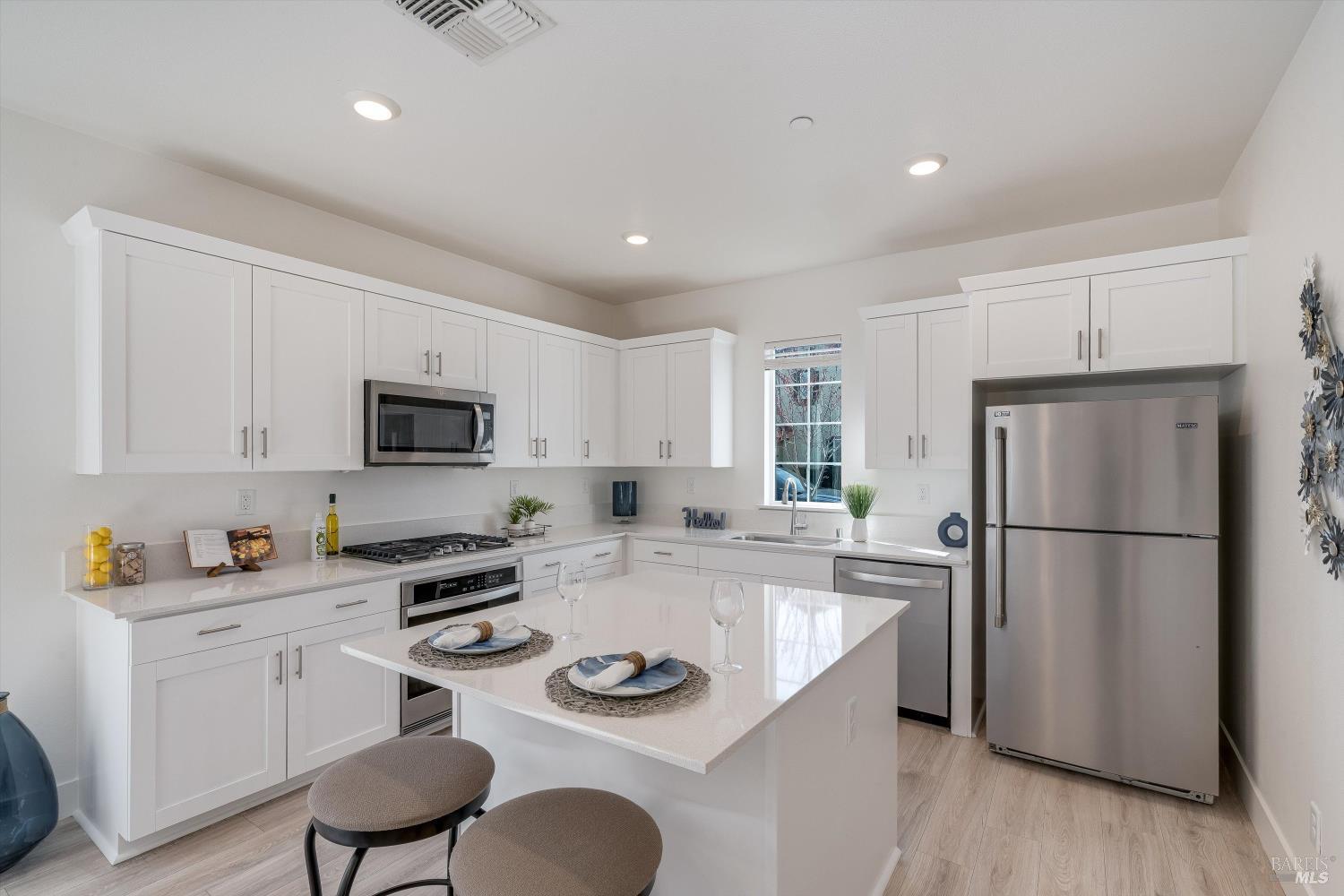 6054 Oxford Place Rohnert Park, CA 94928 - Photo 15 of 44 a kitchen with white cabinets and white appliances