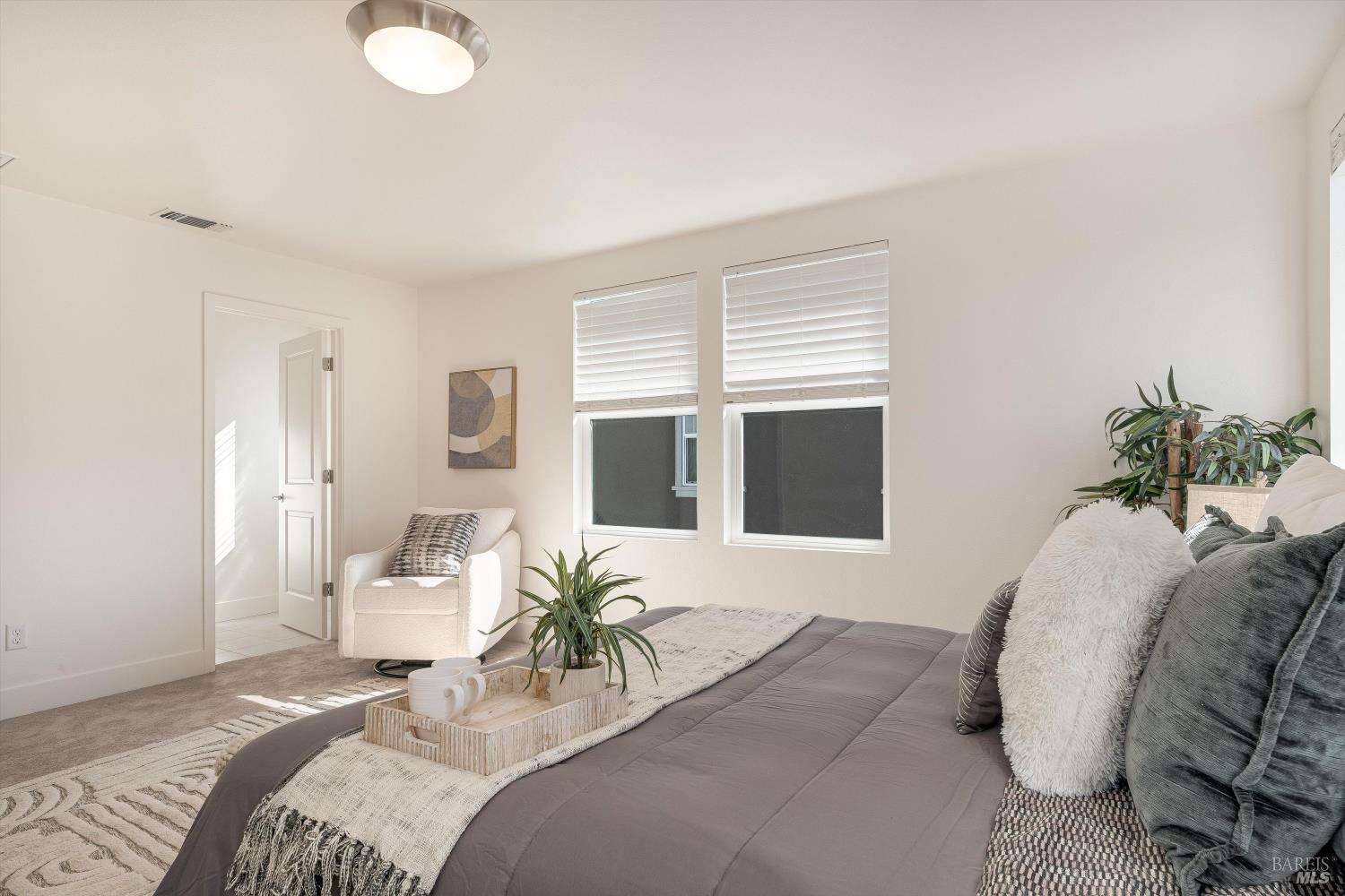 6054 Oxford Place Rohnert Park, CA 94928 - Photo 25 of 44 a bedroom with a bed and glass windows