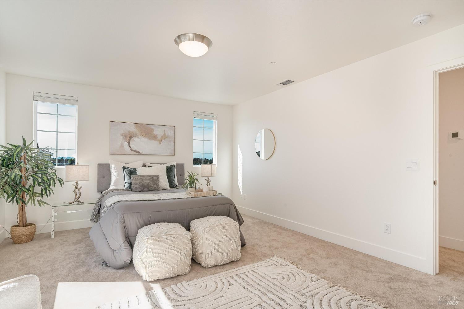 6054 Oxford Place Rohnert Park, CA 94928 - Photo 26 of 44 a bedroom with a large bed and a potted plant