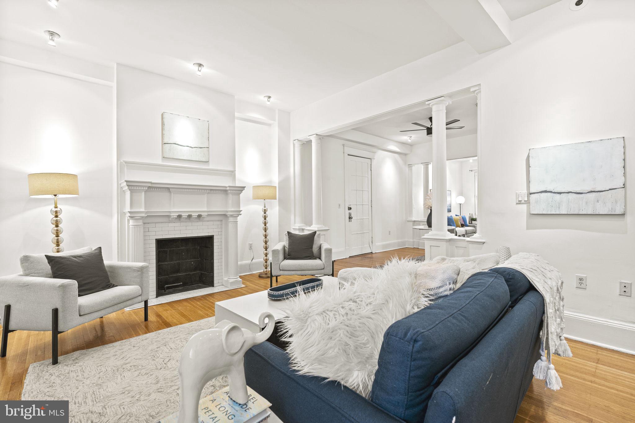 a living room with furniture a fireplace and a table