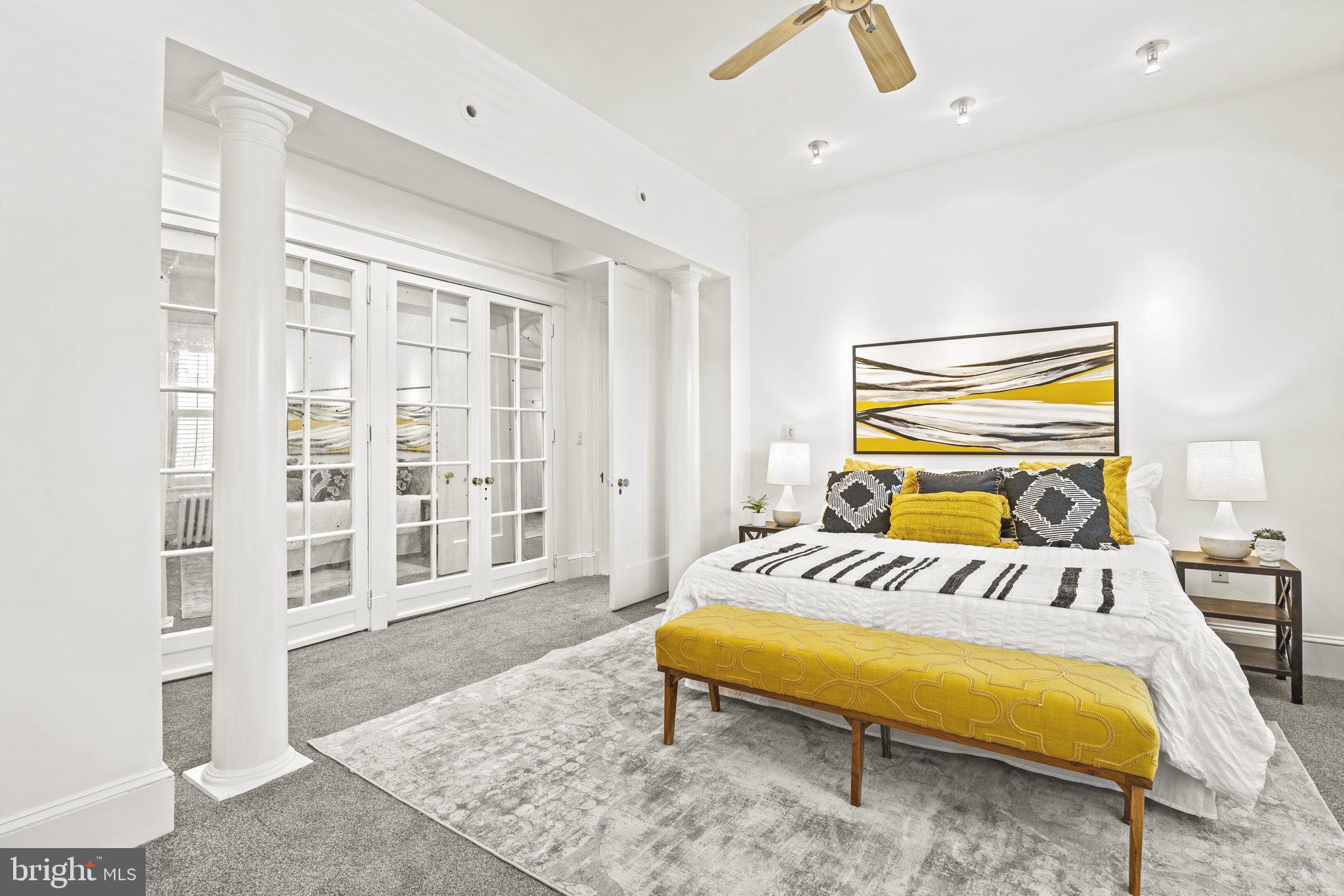 1736 Columbia Road Northwest, Unit 102 Washington, DC 20009 - Photo 14 of 39 a bedroom with a bed and wooden floor