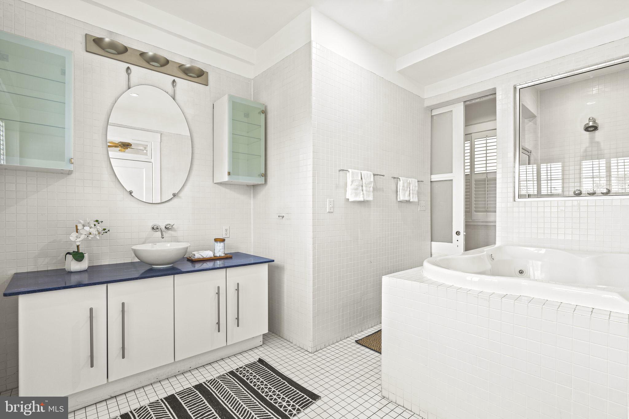 1736 Columbia Road Northwest, Unit 102 Washington, DC 20009 - Photo 17 of 39 a bathroom with a sink and a mirror