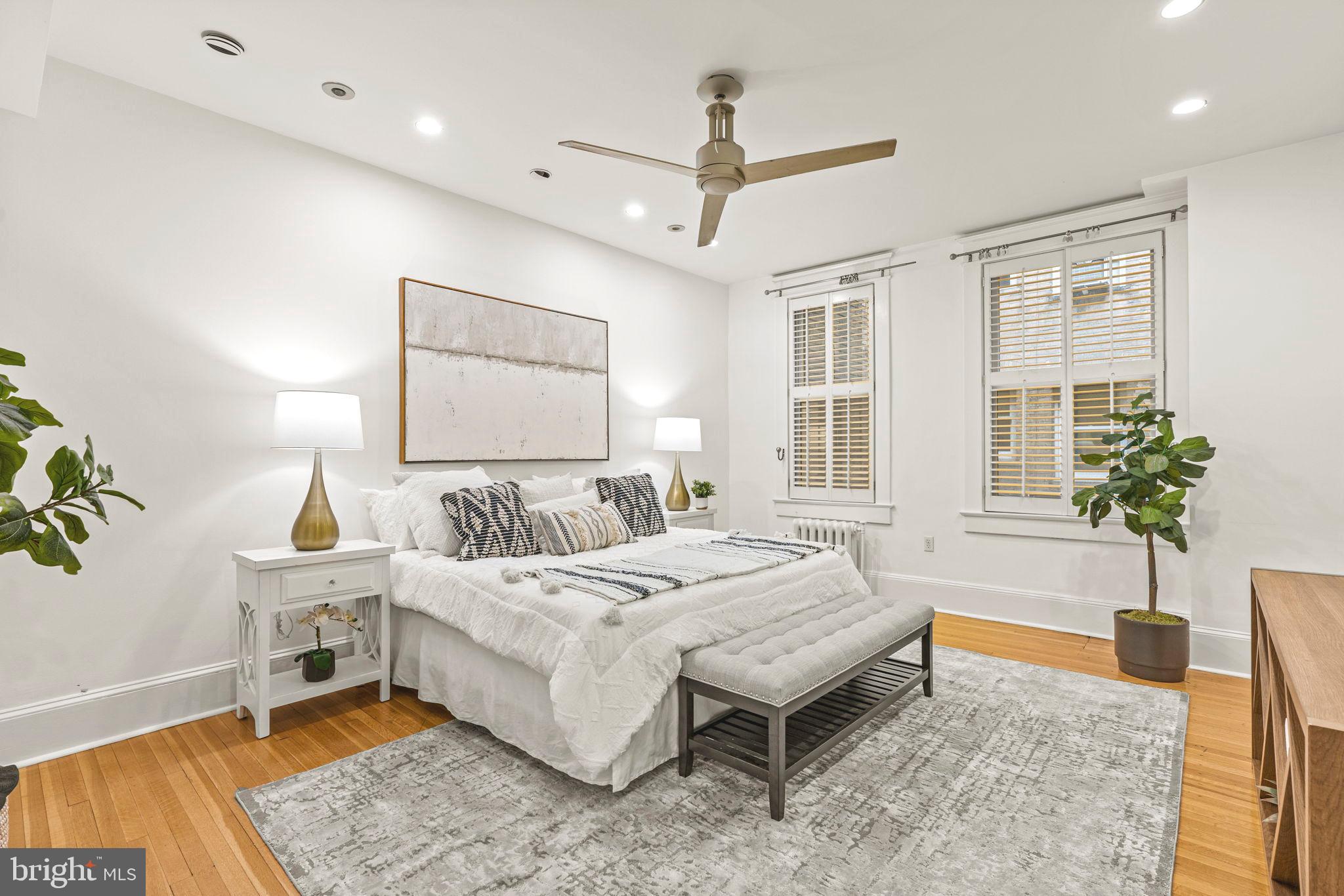 1736 Columbia Road Northwest, Unit 102 Washington, DC 20009 - Photo 22 of 39 a bedroom with a bed and wooden floor