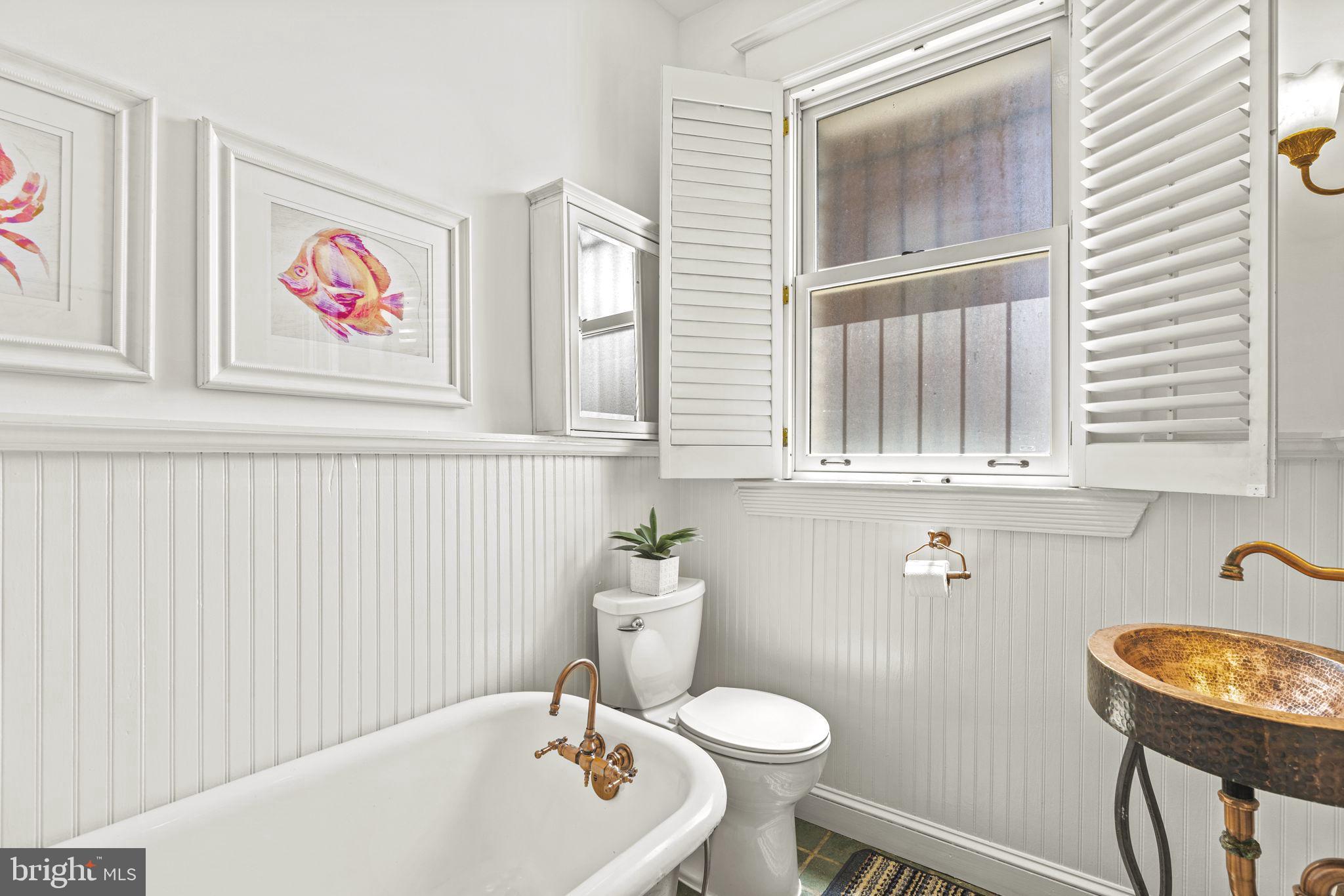 1736 Columbia Road Northwest, Unit 102 Washington, DC 20009 - Photo 24 of 39 a bathroom with a sink a mirror and a toilet