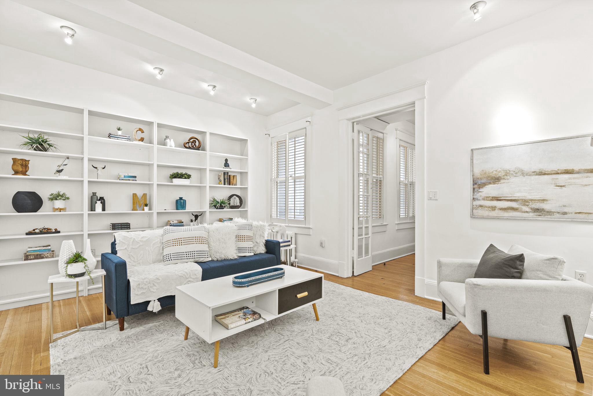 1736 Columbia Road Northwest, Unit 102 Washington, DC 20009 - Photo 3 of 39 a living room with furniture and wooden floor