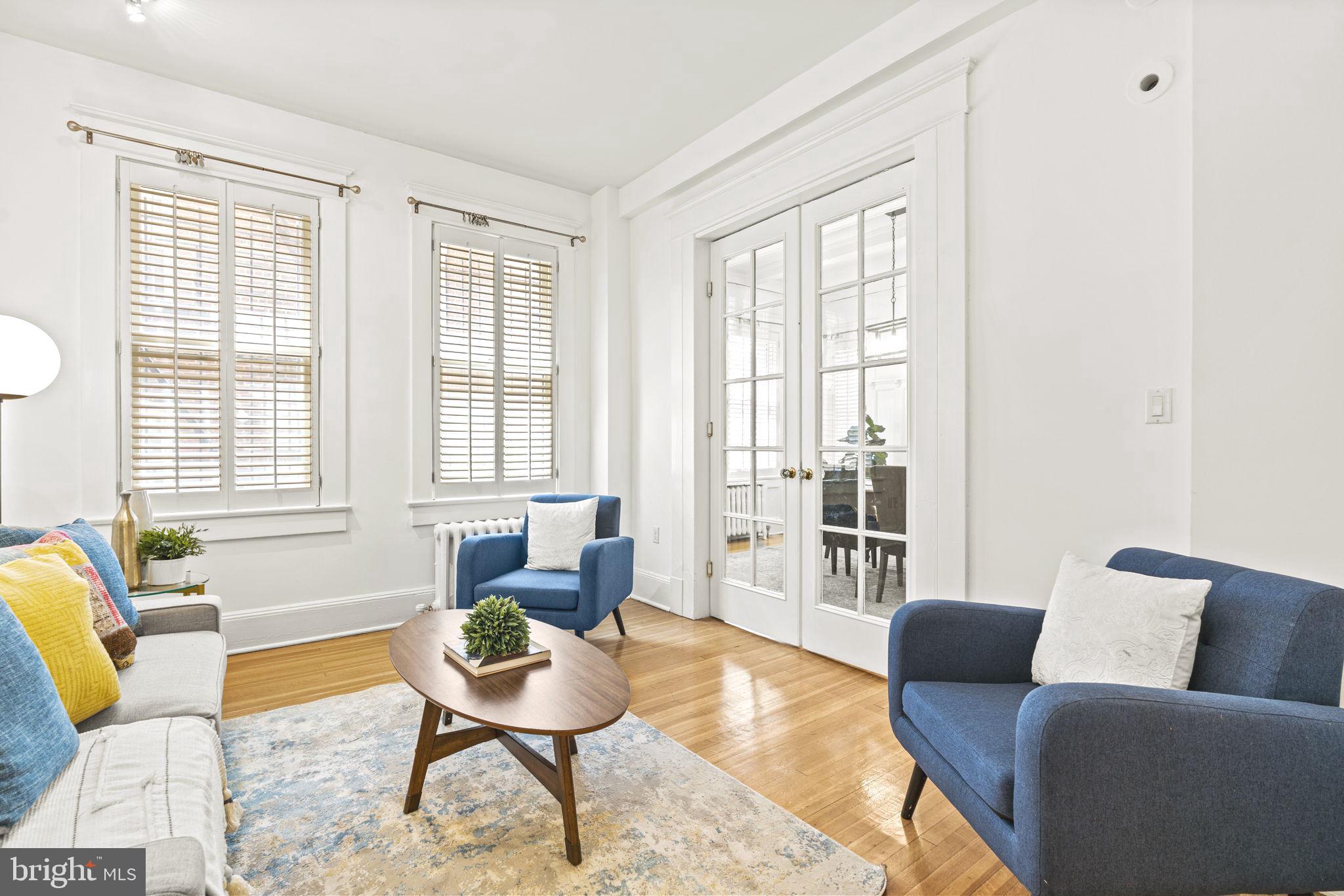 1736 Columbia Road Northwest, Unit 102 Washington, DC 20009 - Photo 7 of 39 a living room with furniture and a window
