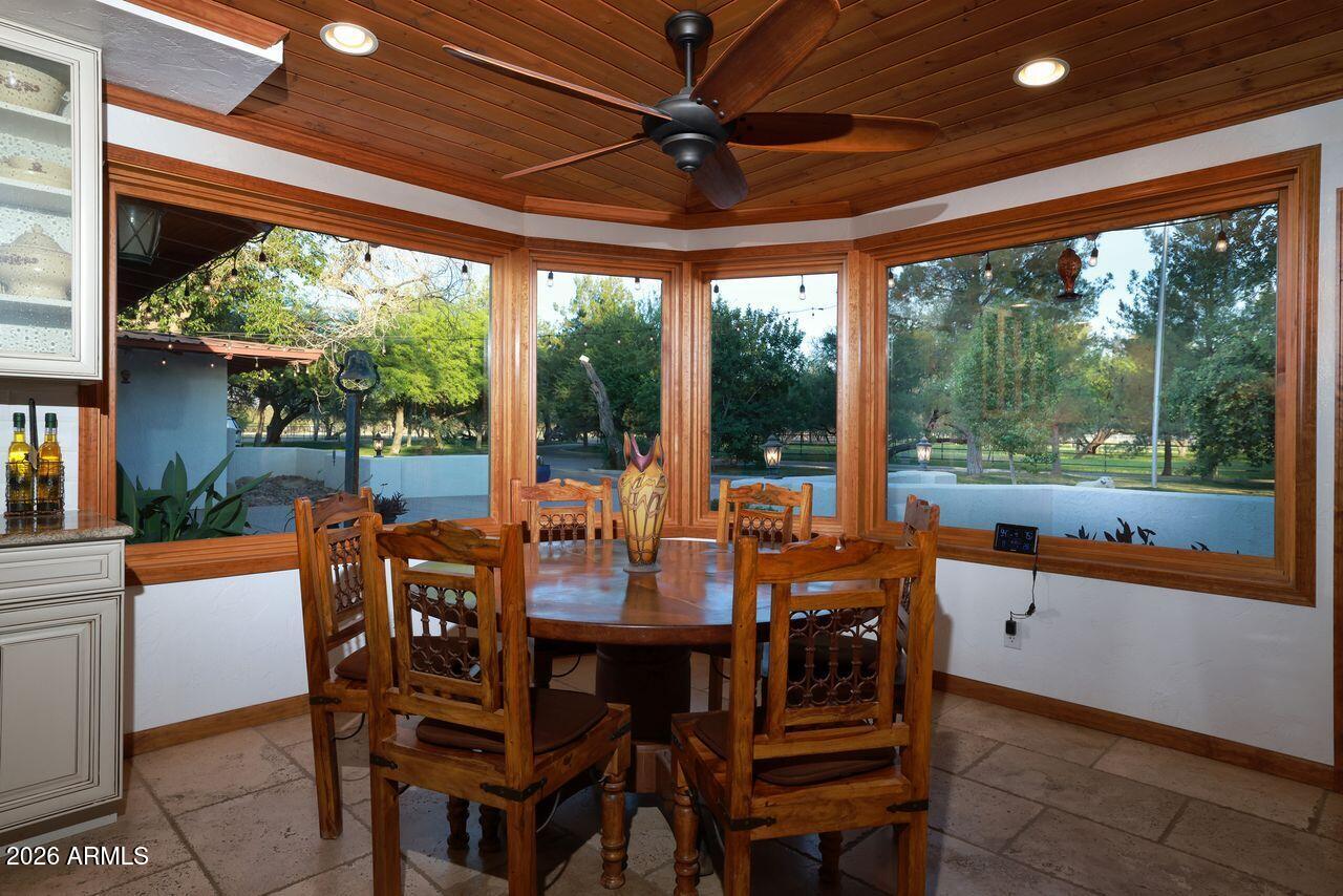 8741 East Woodland Road Tucson, AZ 85749 - Photo 17 of 51 a view of a dining room with furniture window and outside view