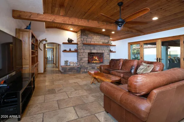 a living room with furniture a fireplace and a flat screen tv