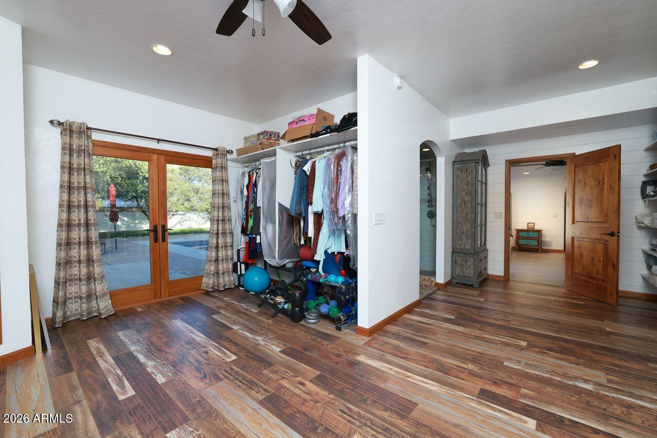 8741 East Woodland Road Tucson, AZ 85749 - Photo 24 of 51 a view of livingroom with hardwood floor and ceiling fan