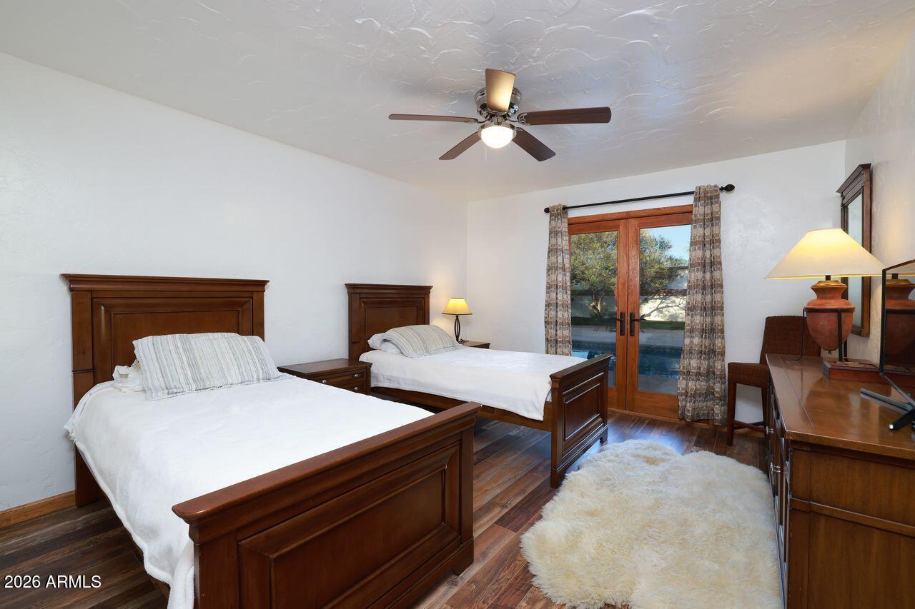 8741 East Woodland Road Tucson, AZ 85749 - Photo 26 of 51 a bedroom with two beds and painted walls