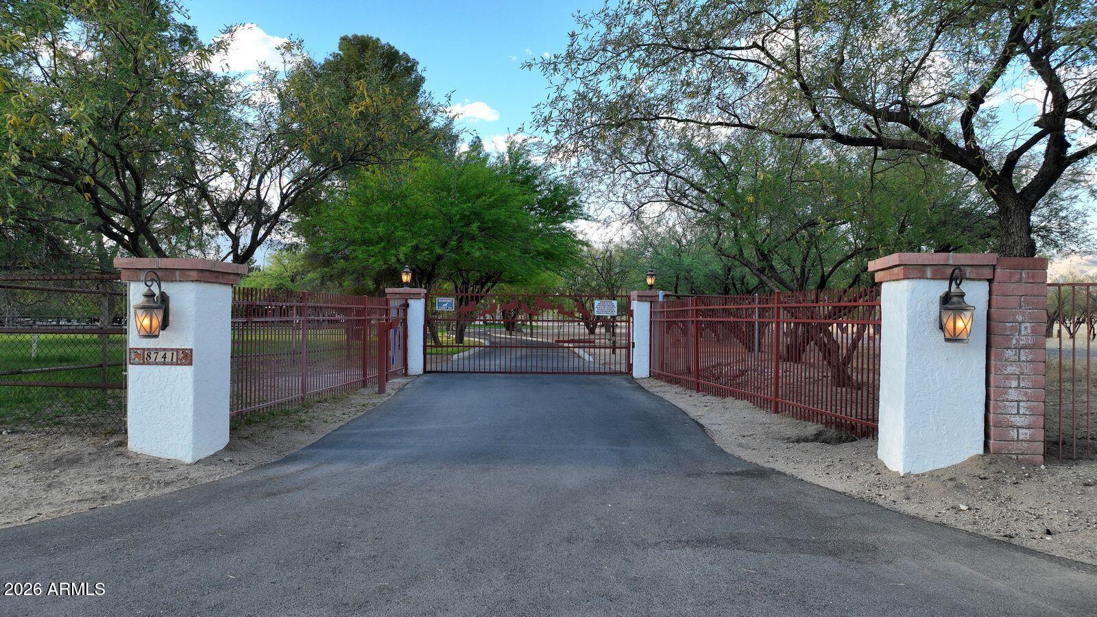 8741 East Woodland Road Tucson, AZ 85749 - Photo 2 of 51 a view of a street with large trees