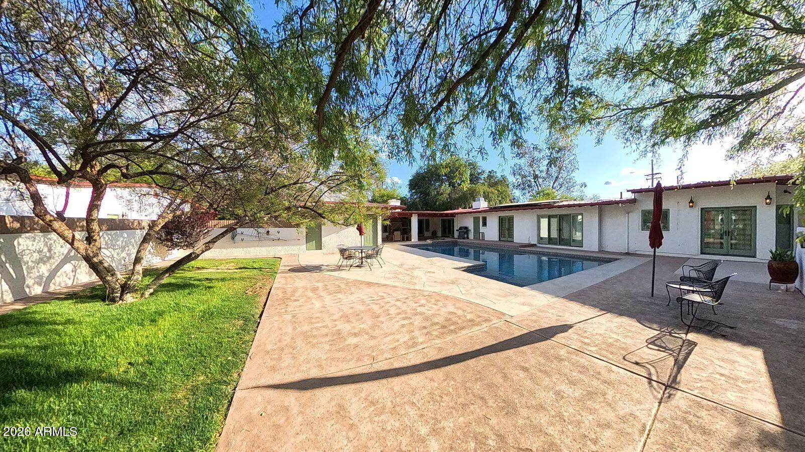 8741 East Woodland Road Tucson, AZ 85749 - Photo 40 of 51 a view of a backyard with a garden and trees