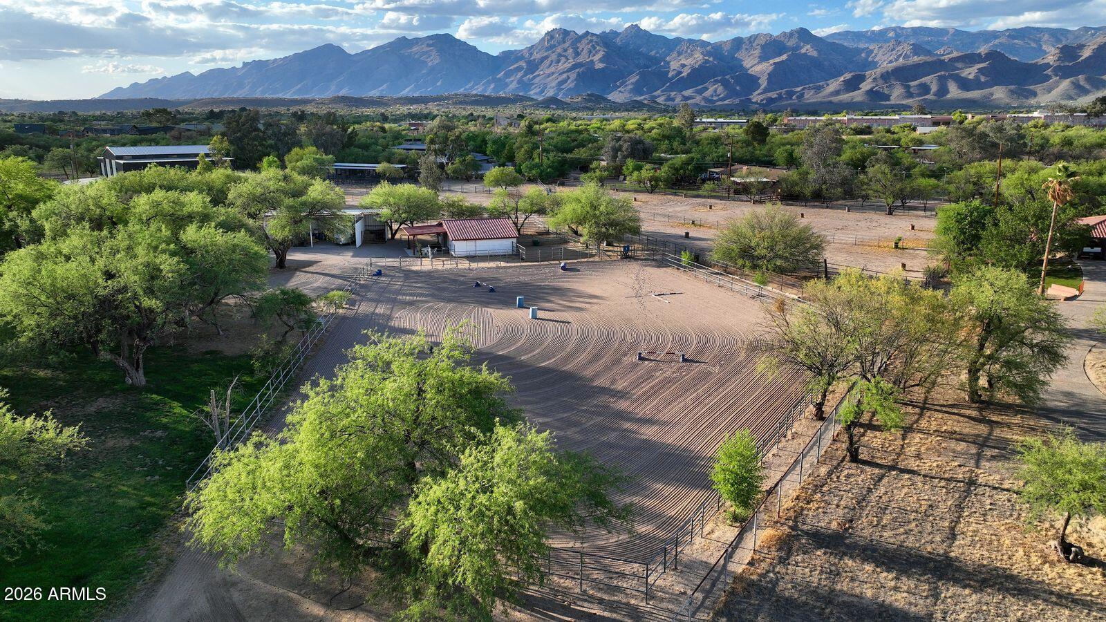 8741 East Woodland Road Tucson, AZ 85749 - Photo 4 of 51 a view of a patio with a table and chairs under an umbrella