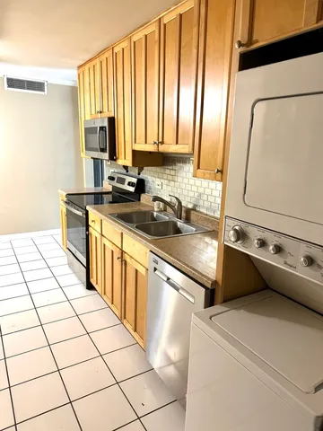 a kitchen with a sink cabinets and appliances