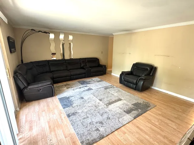 a living room with a couch and a rug