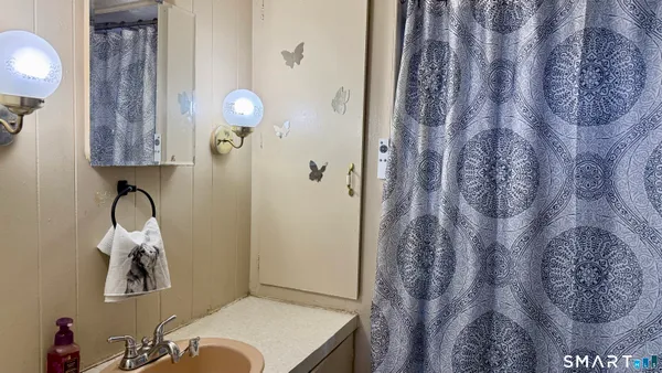 a bathroom with a bathtub and shower curtain