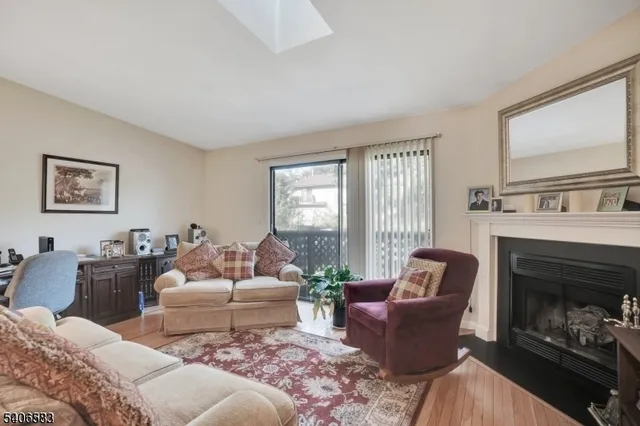 a living room with furniture fireplace and window