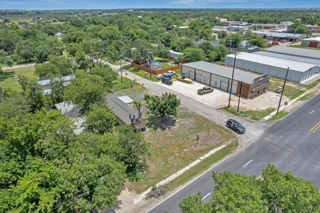 an aerial view of a house with a yard