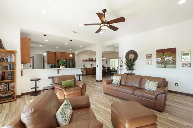 a living room with furniture and a view of kitchen