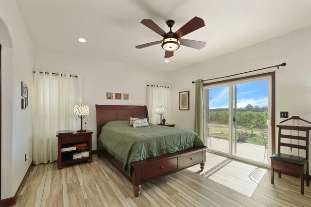 a bedroom with a large bed and a large window