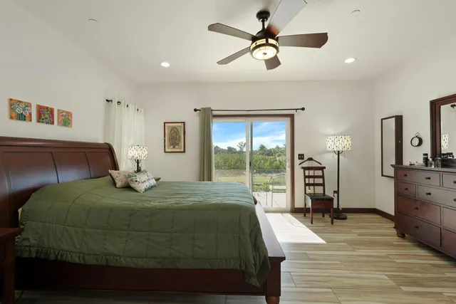a bedroom with a large bed and a large window