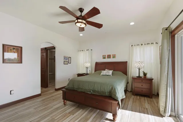 a bedroom with a bed and a large mirror