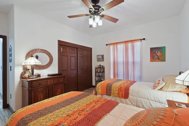 a bedroom with a bed and a chandelier