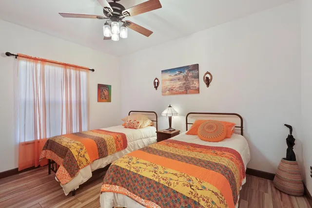 a bedroom with two beds and a chandelier