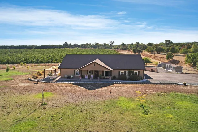 an aerial view of a house with big yard