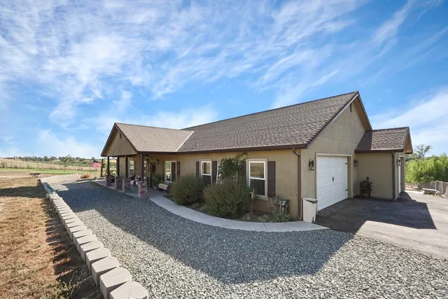 a front view of house with yard and lake view
