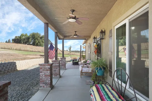 a very nice looking room with a large window and potted plants