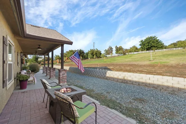a view of a backyard with lawn chair and couches