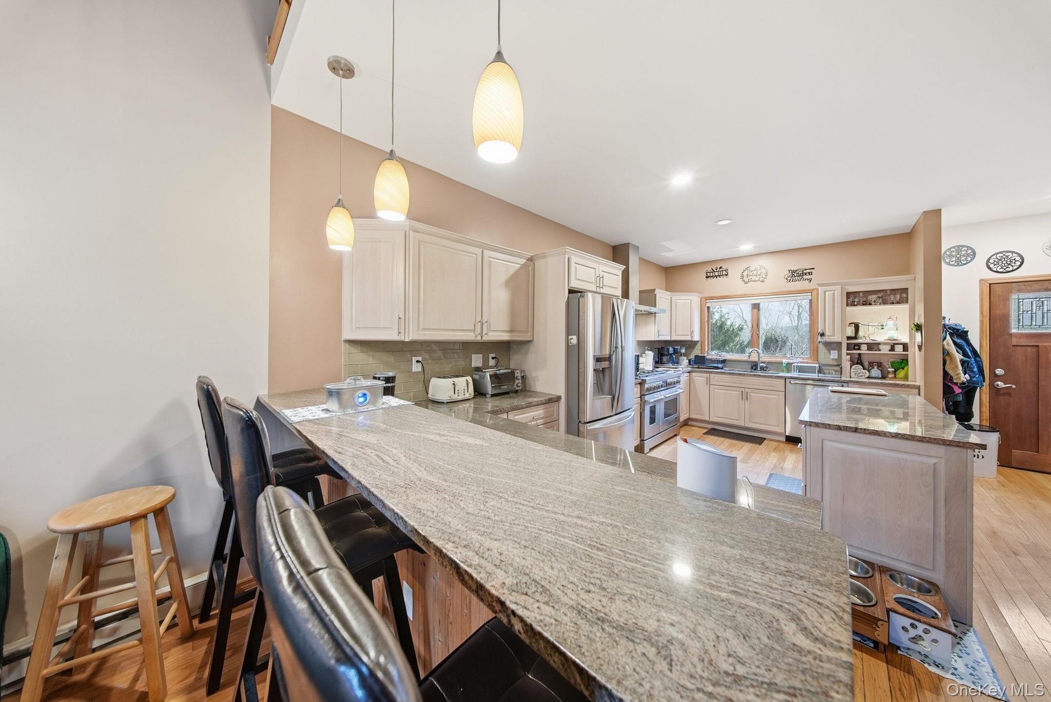 191 David Rhodes Road Wurtsboro, NY 12790 - Photo 12 of 39 a kitchen with stainless steel appliances granite countertop a stove refrigerator and cabinets