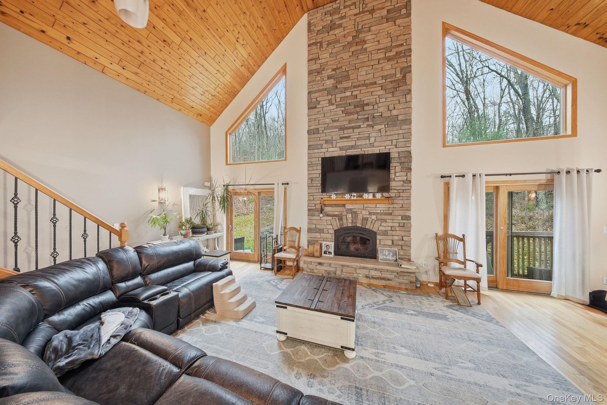 191 David Rhodes Road Wurtsboro, NY 12790 - Photo 15 of 39 a living room with furniture a fireplace and a floor to ceiling window