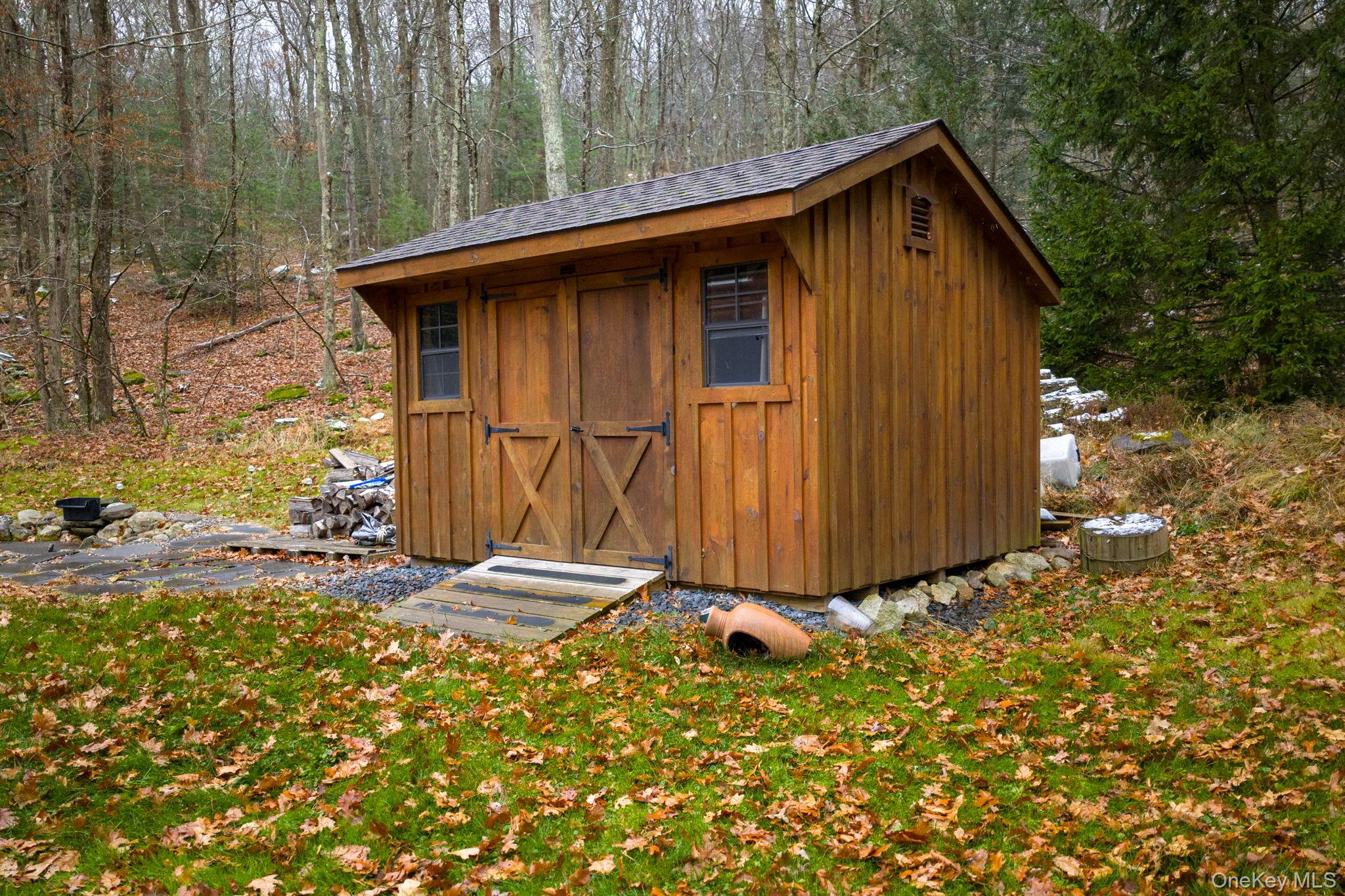 191 David Rhodes Road Wurtsboro, NY 12790 - Photo 37 of 39 a view of wooden house with a small yard and large trees