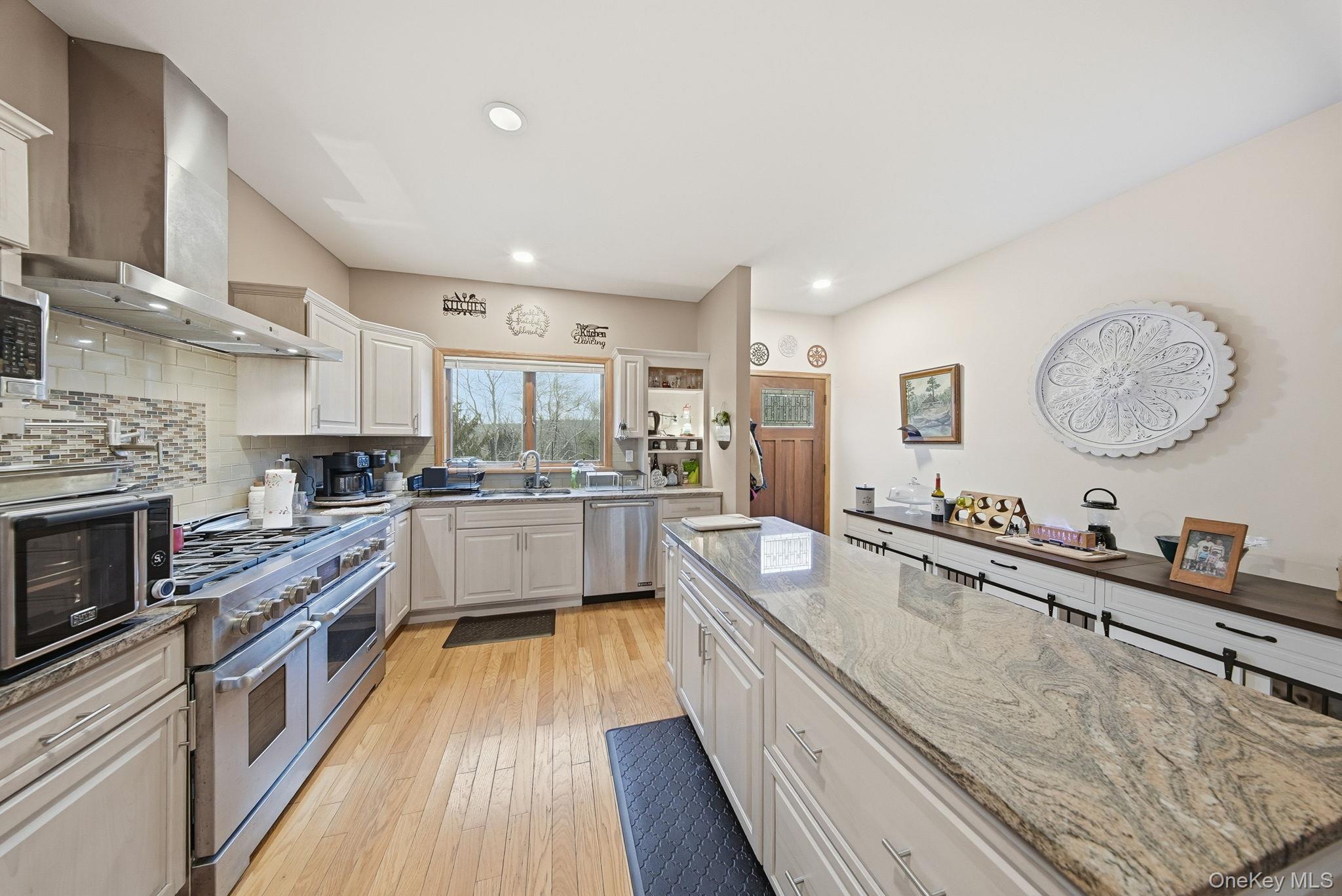 191 David Rhodes Road Wurtsboro, NY 12790 - Photo 6 of 39 a large kitchen with stainless steel appliances granite countertop a lot of counter space and wooden floors