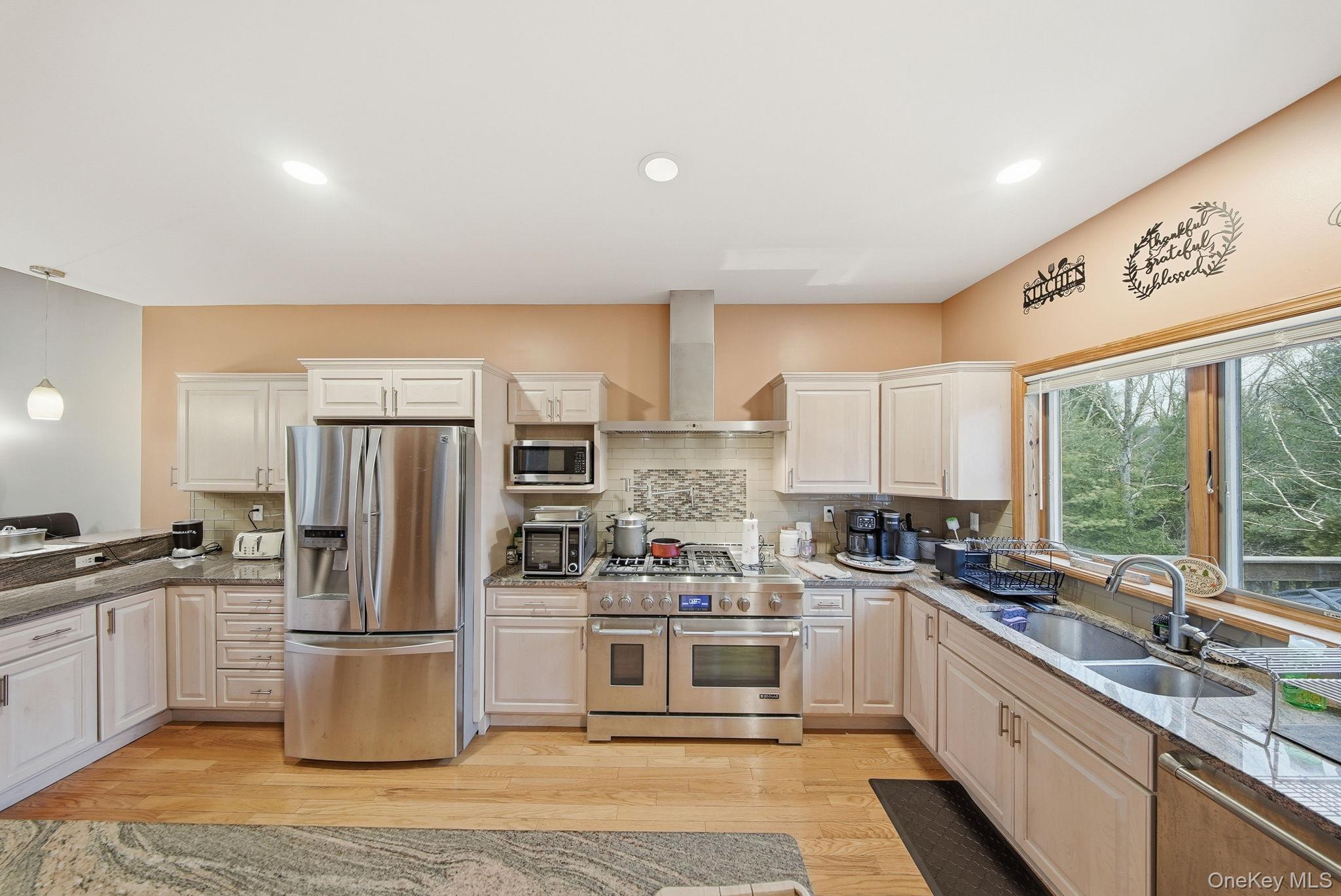 191 David Rhodes Road Wurtsboro, NY 12790 - Photo 8 of 39 a kitchen with a refrigerator a sink a stove top oven and cabinets