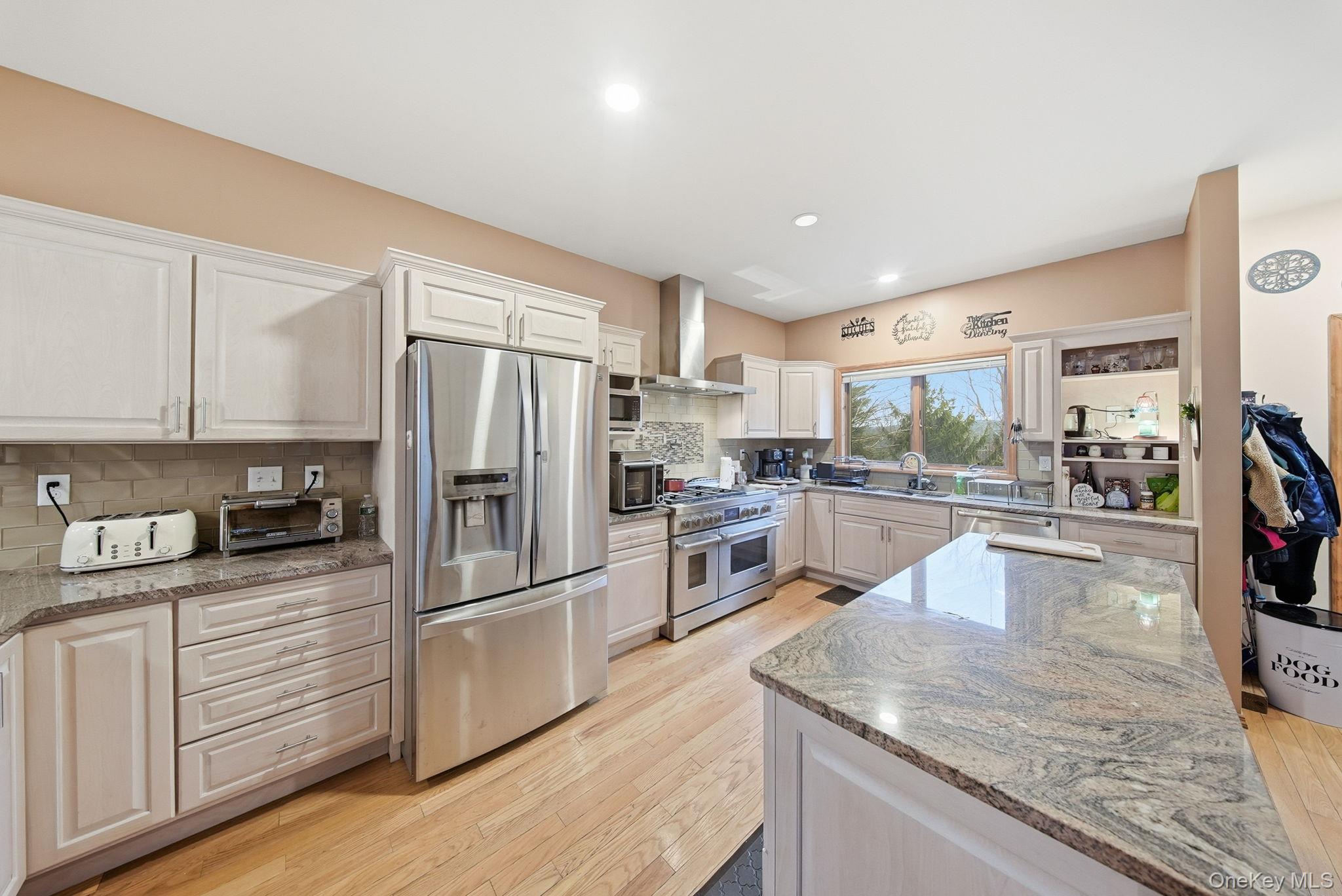191 David Rhodes Road Wurtsboro, NY 12790 - Photo 10 of 39 a kitchen with stainless steel appliances granite countertop a refrigerator a stove and a sink with wooden floors