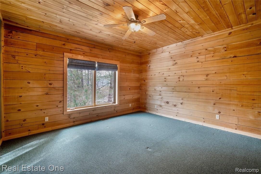 9485 Henderson Road Goodrich, MI 48438 - Photo 25 of 50 NOTTY PINE ADORNS THE 3RD MAIN LEVEL BEDROOM