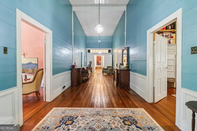 a view of a hallway with wooden floor