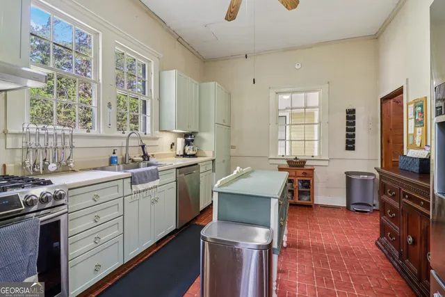a kitchen with sink cabinets and window