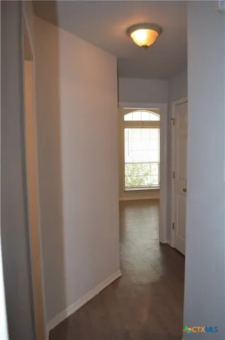 a view of an empty room and a window