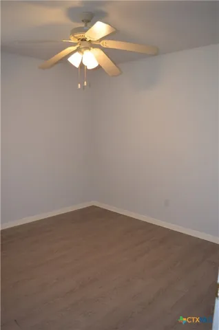 a view of a room with a chandelier fan