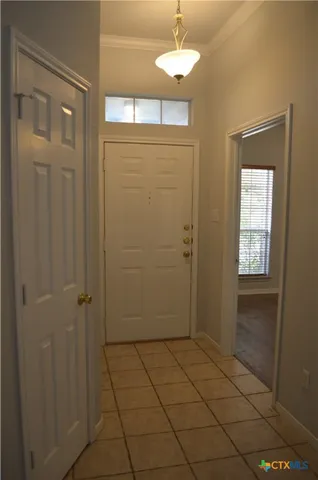 an empty room with a fireplace and wooden floor